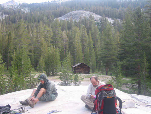 Dave and Foo'ball in our Bug Arroyo campsite with historical ranger cabin in background