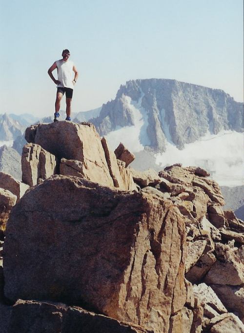 Schmed atop Mt. Lamarck with Mt. Darwin behind him.