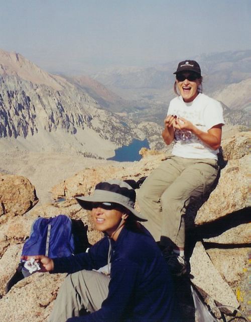 Leslie and Kirsten celebrate on the summit of Mt. Lamarck with Darwin Canyon in the background.